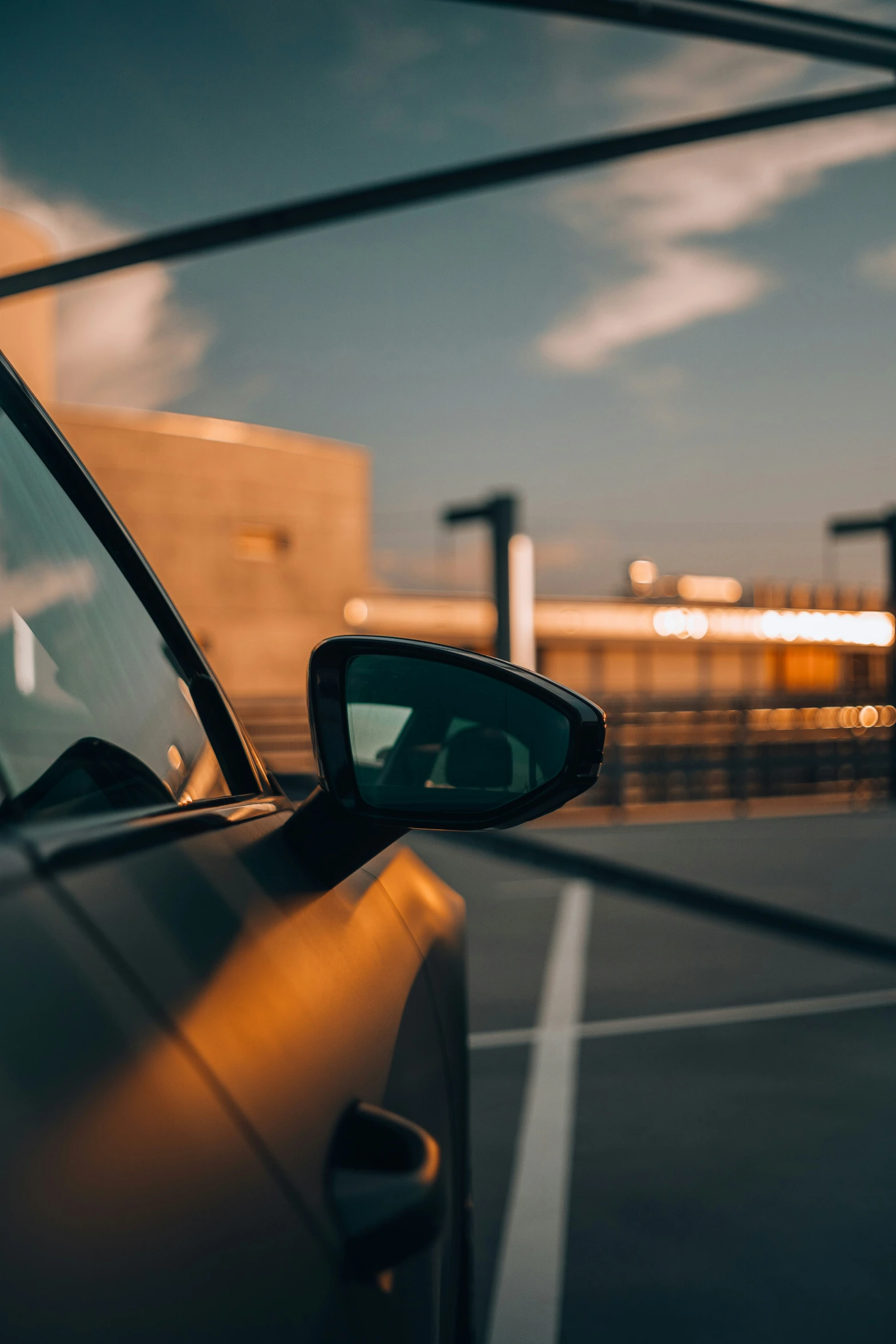 side view mirror of a car with buildings in the background