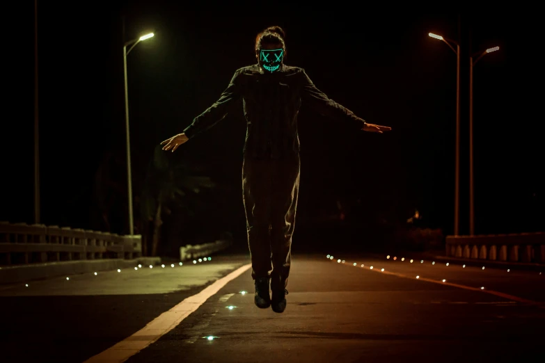 a person is walking on a road during the night