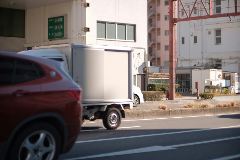 a big white box truck driving down the street