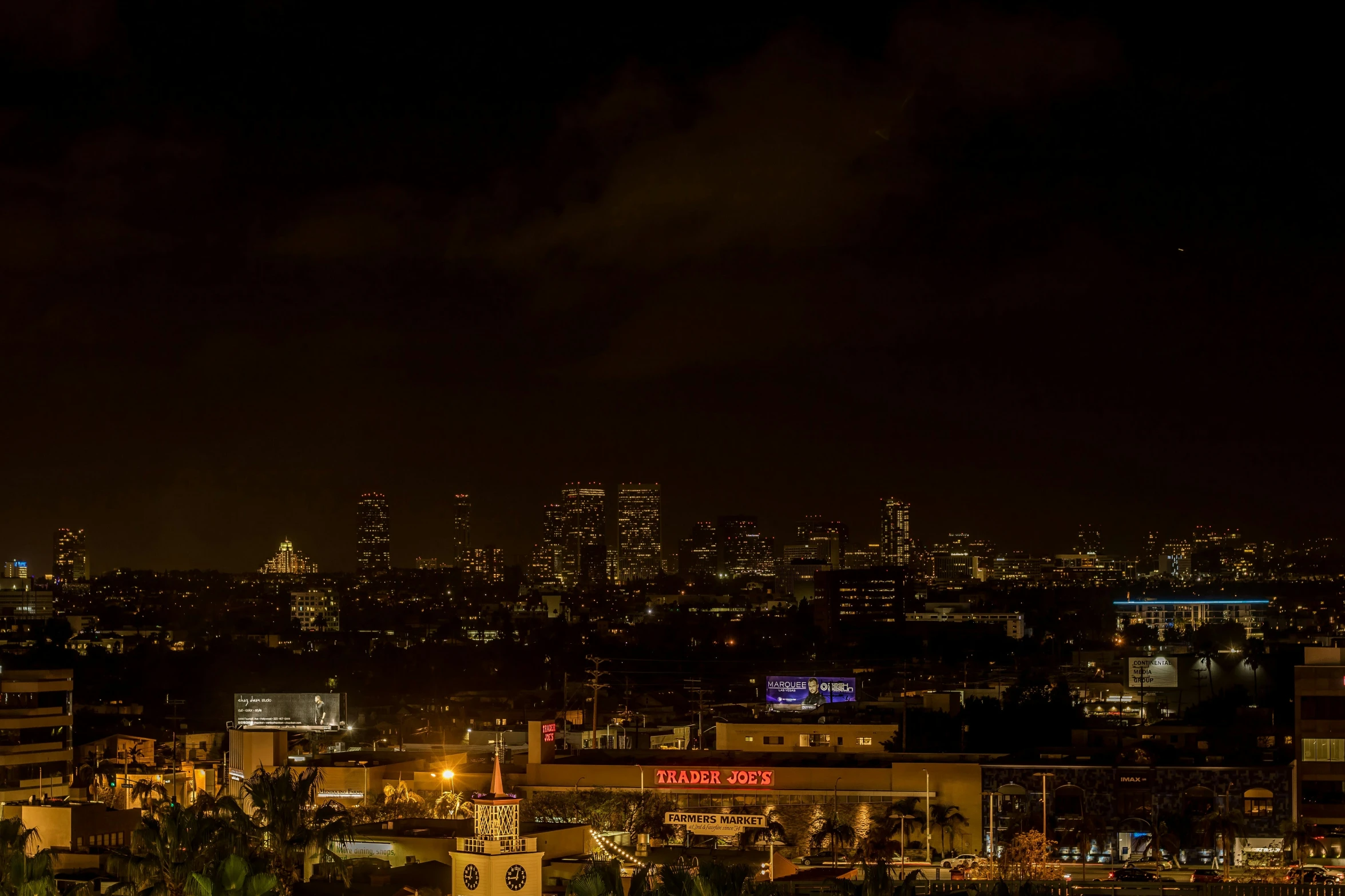 the city skyline is illuminated in bright lights