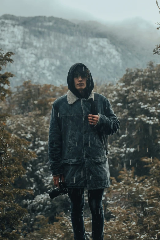 a man standing in front of a snowy mountain