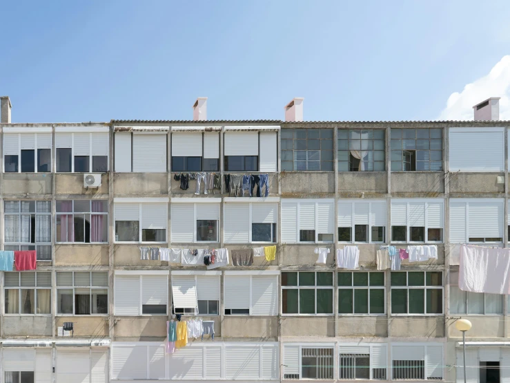 a building with some windows, clothes hanging out to dry