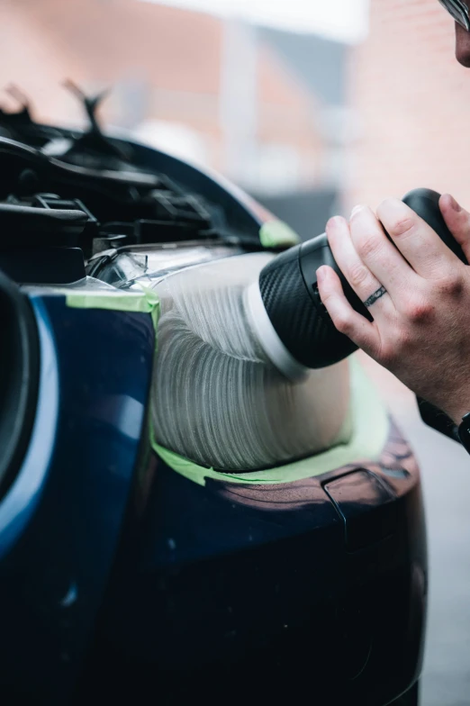 a close up of a person fixing a car engine