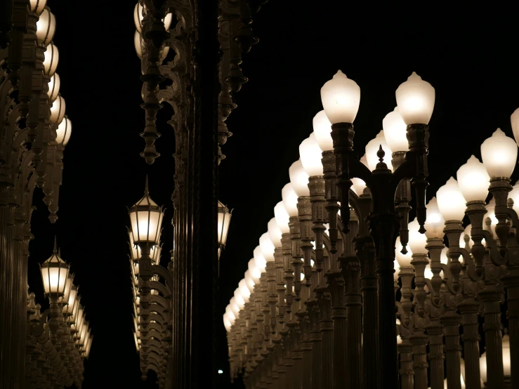 a row of lights that are lit up against a black background