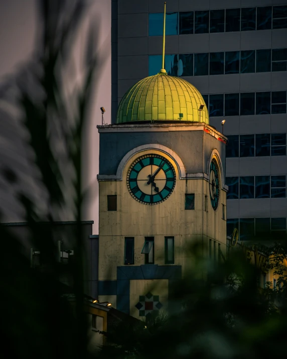 a clock tower next to some building under construction