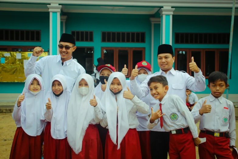 there is a group of children that are standing with their teacher