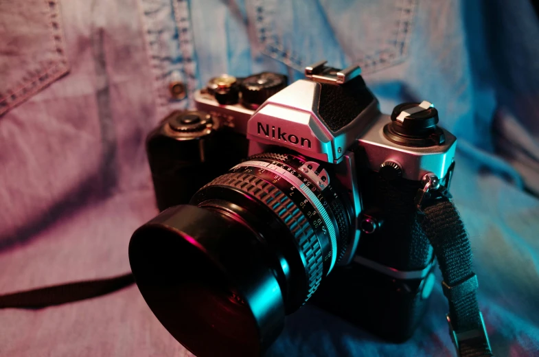 an old, antique camera sits on the lap of someone