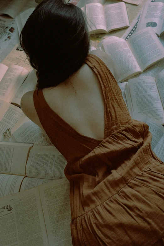 a woman sitting at a table with books