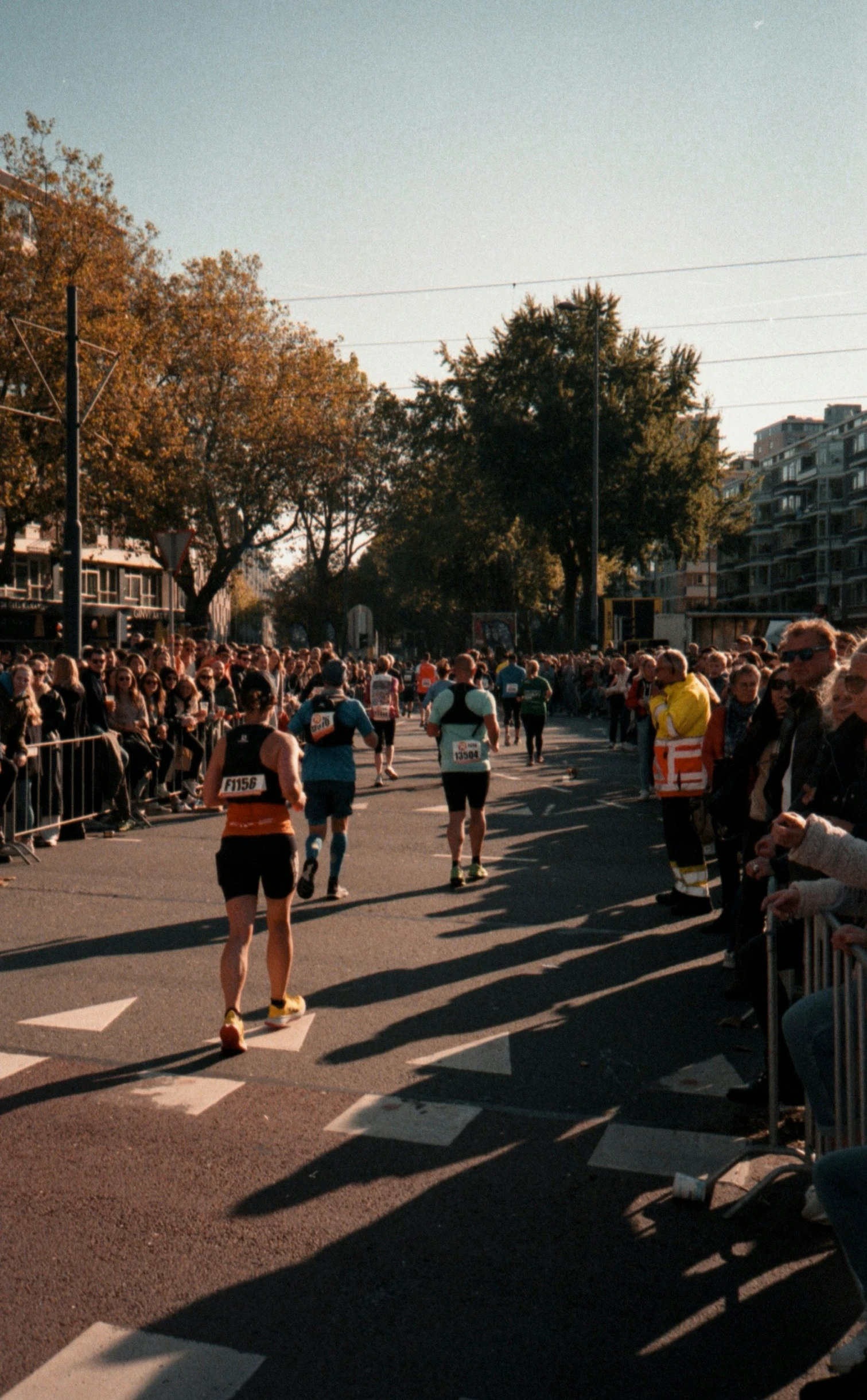 a group of people walking on a street in front of a crowd