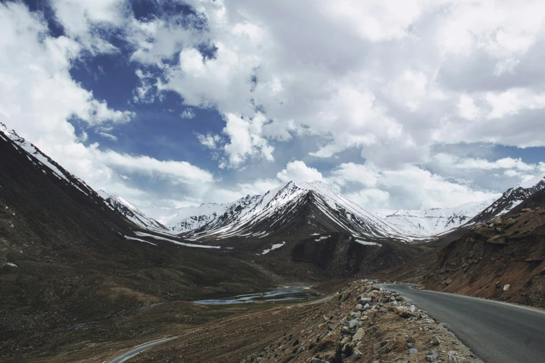 the winding road winds through mountains to an empty parking lot