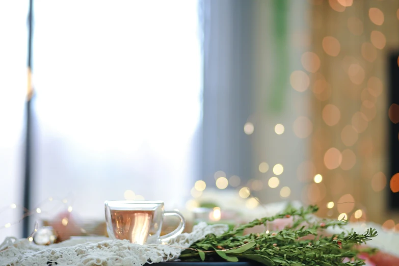 a white table with an empty glass cup on it