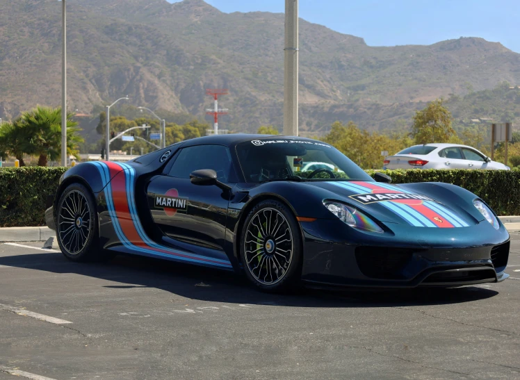 the sports car is painted with red, white, and blue stripes