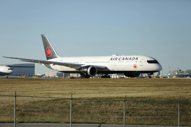 two large jet airliners parked on the runway of an airport