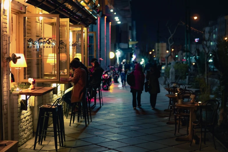 a busy street with people walking on the sidewalk