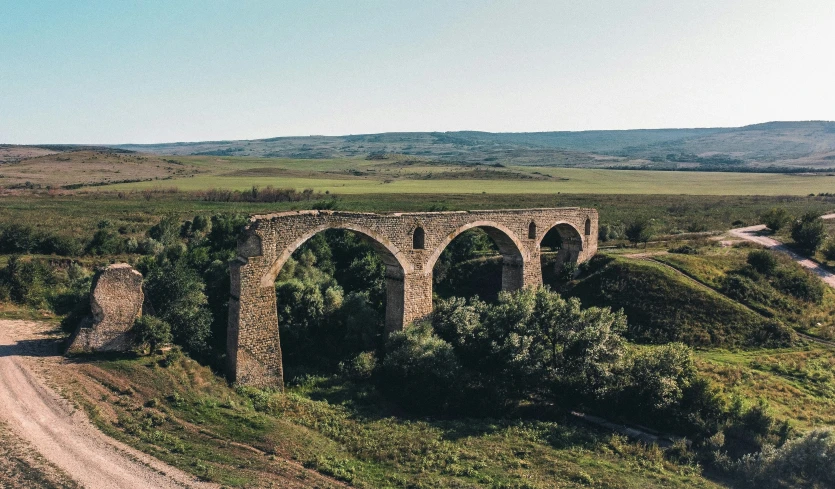 an old stone bridge in the middle of nowhere