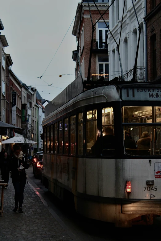 a city street filled with trolleys and pedestrians