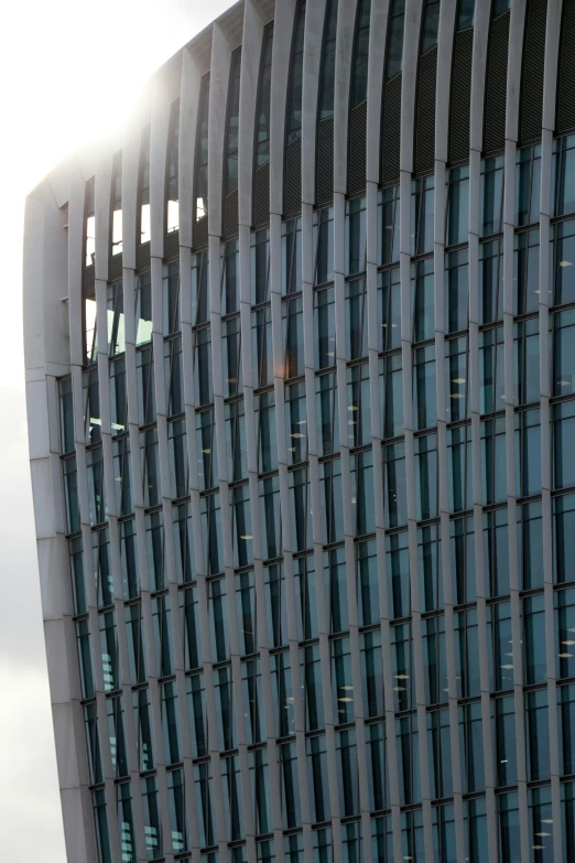 the modern structure of a building with lots of glass windows