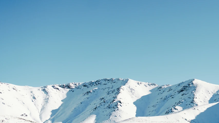 a man skiing on a snow covered mountain