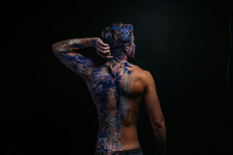 a man with many colored powder on his body