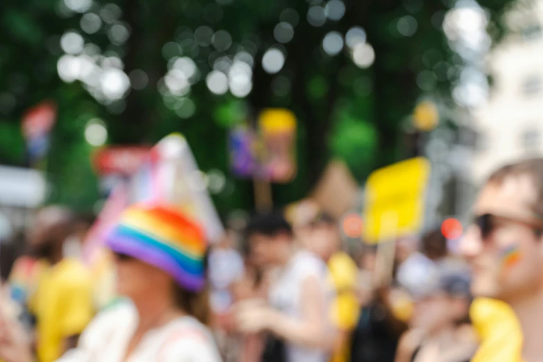 many people wearing colorful hats and holding signs