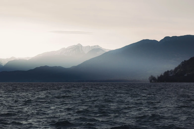 there is a boat in the water by some mountains