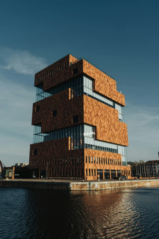 a large building sitting above water next to a pier