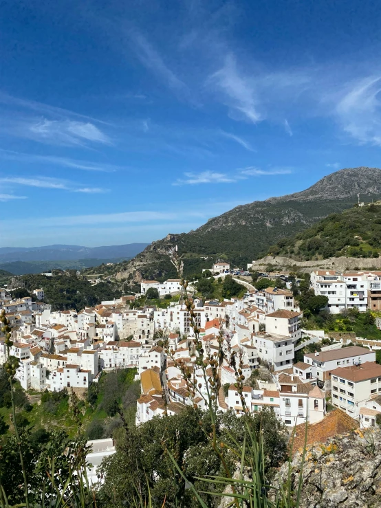 a town surrounded by hills on a sunny day