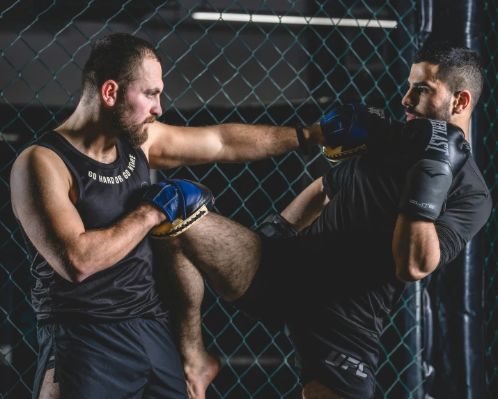 a man is doing a leg split in front of another man