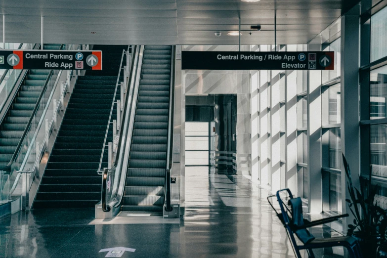 a row of steps with signs leading up the side of each and a couple of empty chairs sitting on the second floor