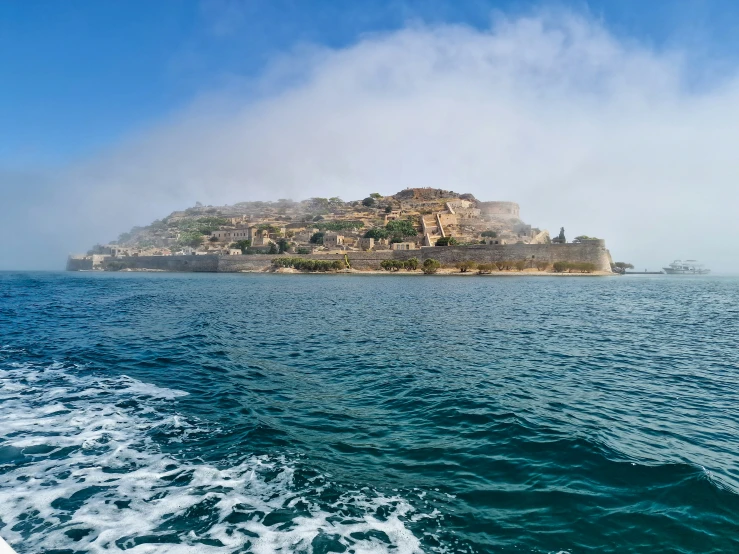 an island is in the middle of a body of water