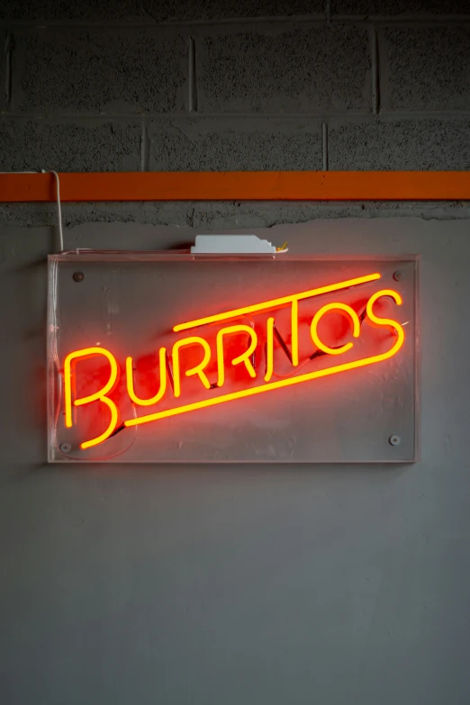 a neon sign hanging from a brick wall