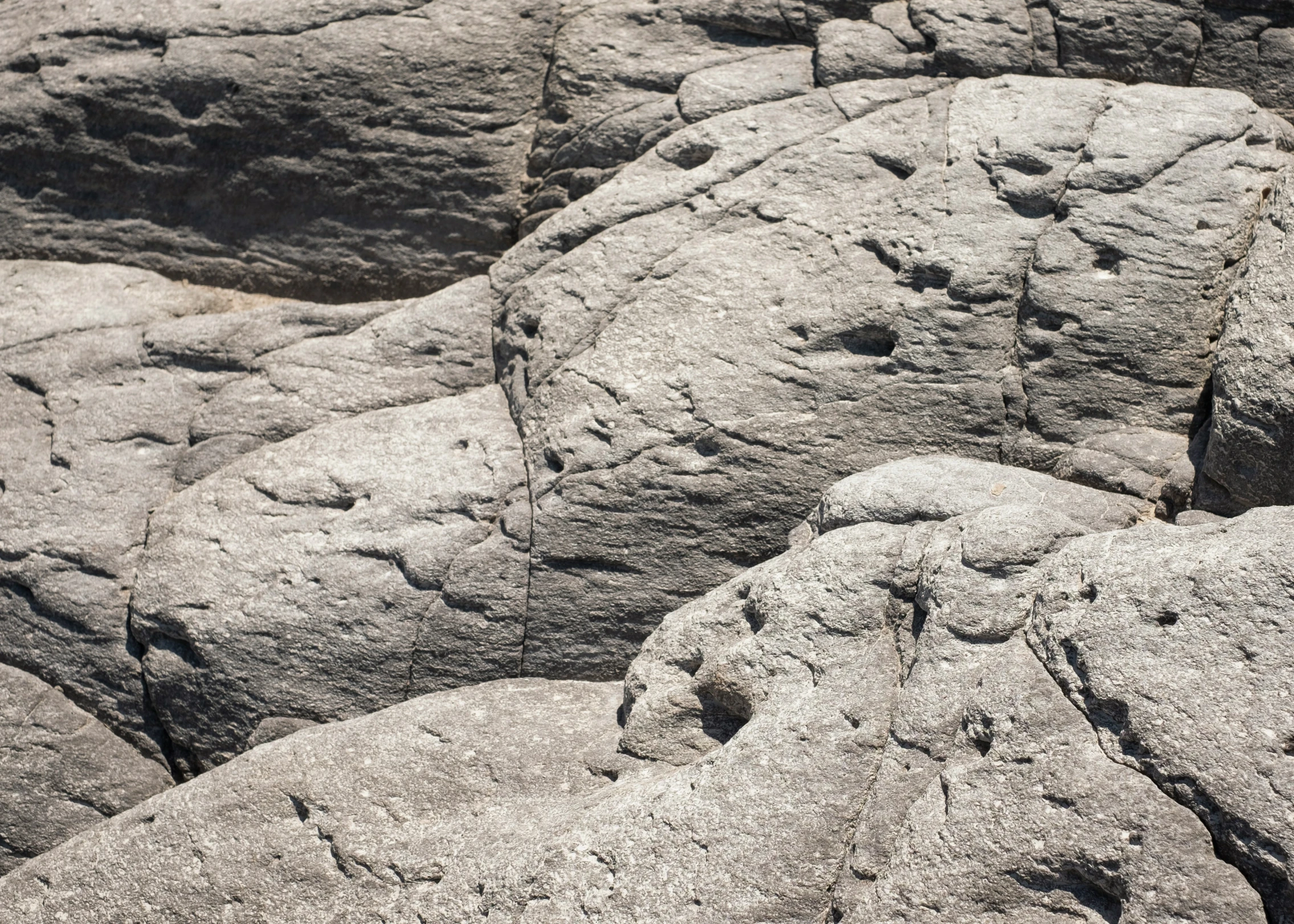 large, gray rocks with rocks and dirt in the background