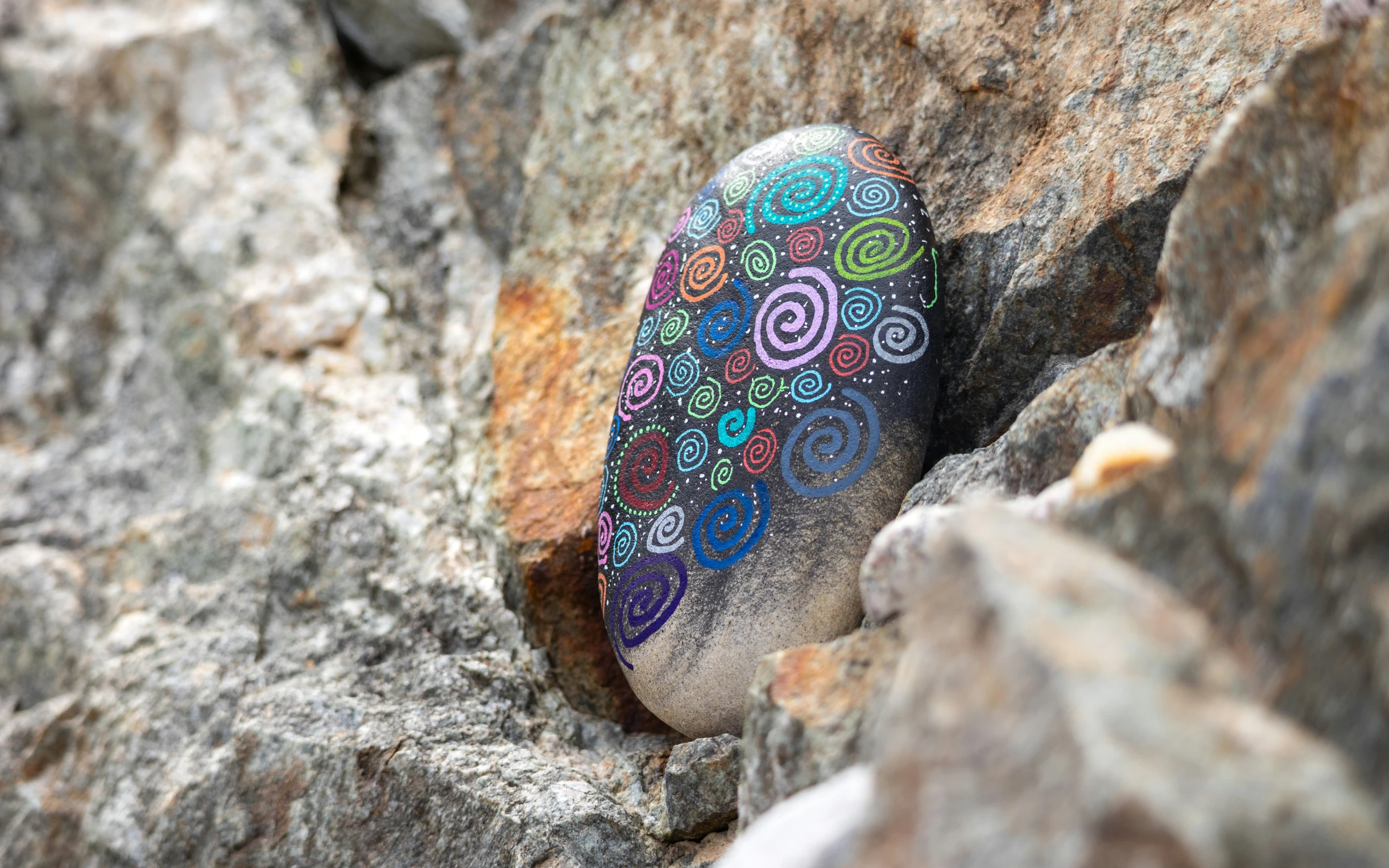 rocks have a colorfully decorated rock embedded in them