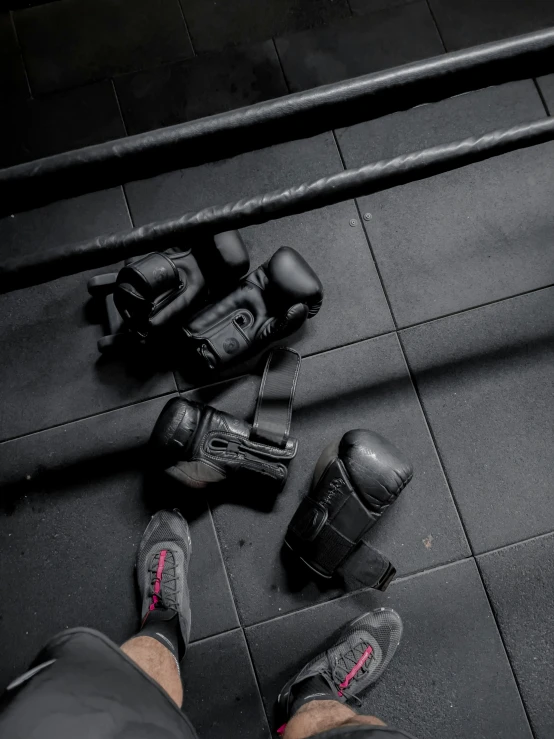 a person wearing black and pink shoes near some exercise equipment