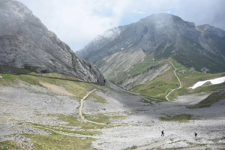 some people are walking up the side of a hill