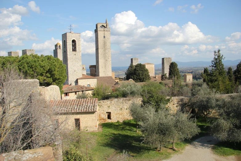 a castle is surrounded by old trees and old buildings