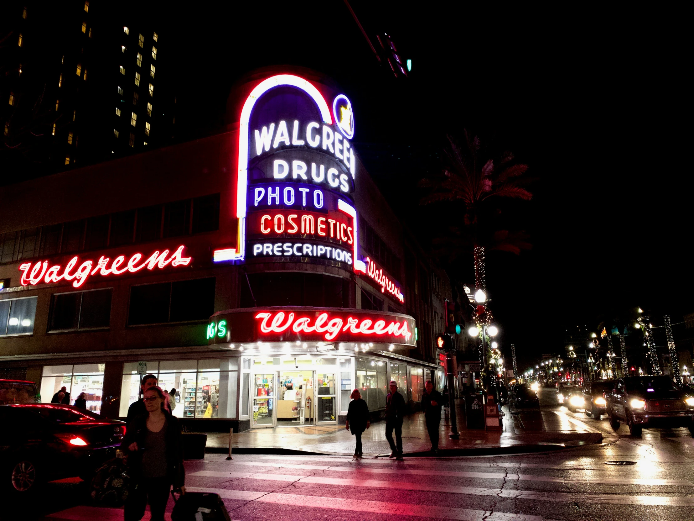 a very pretty building with neon signs on it