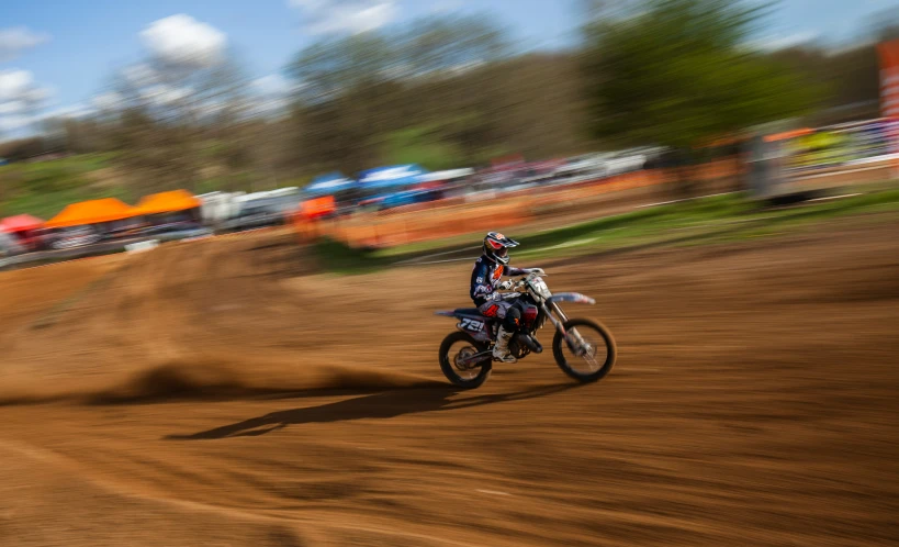 a dirt bike rider rides through a brown area