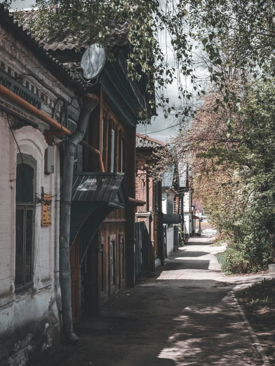 this is an alley between buildings with a clock on top