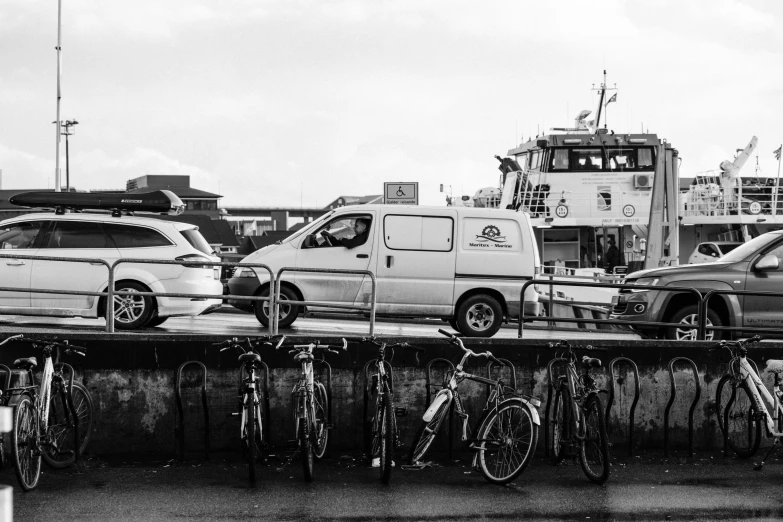 a group of parked vehicles next to bicycles