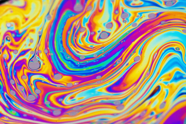 a picture with a multicolored liquid substance pattern on it