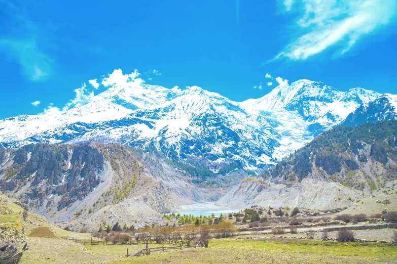 a large mountain range sitting near a valley