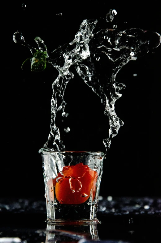 a orange in a glass of water on the table