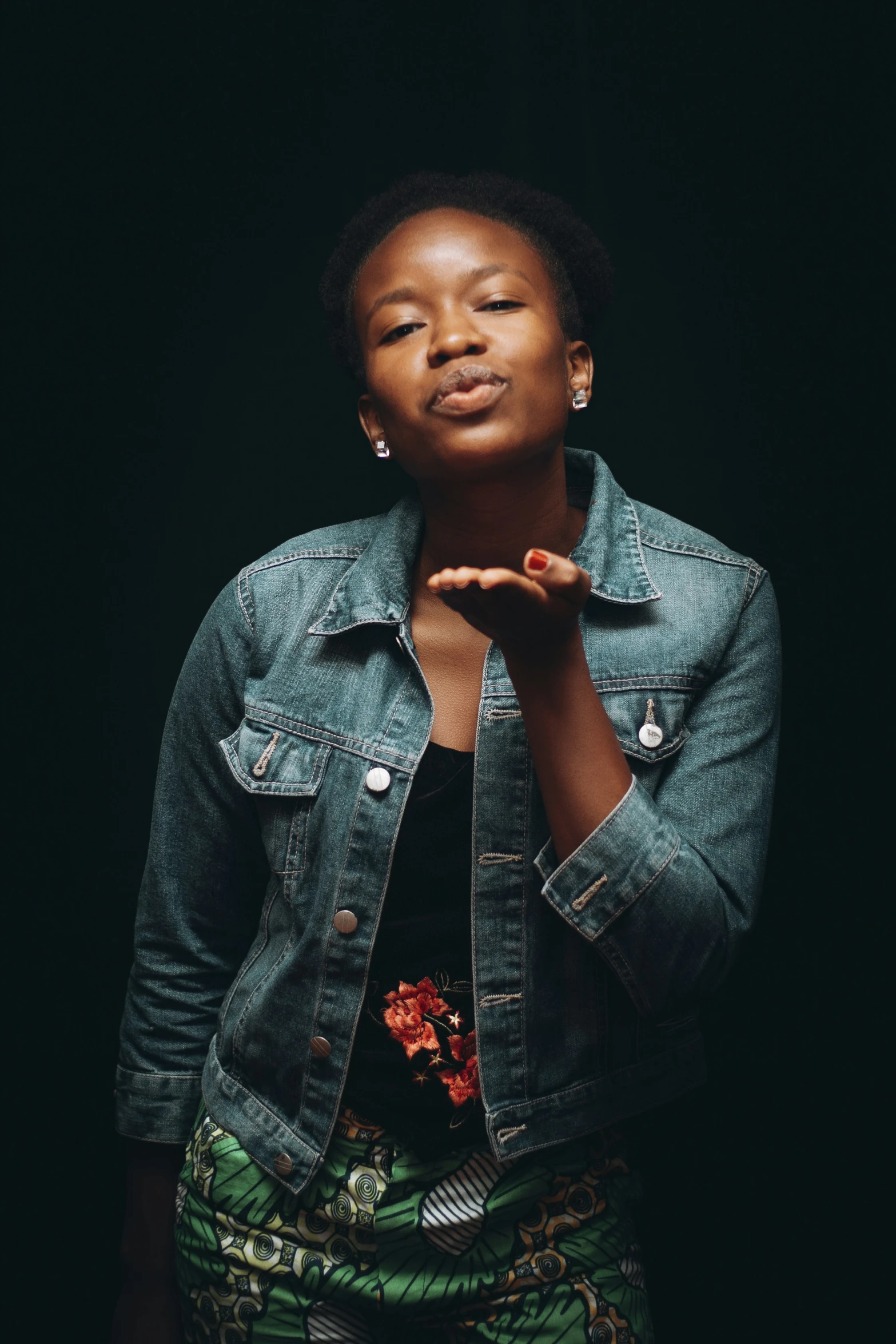 a black woman is posing with her hands together