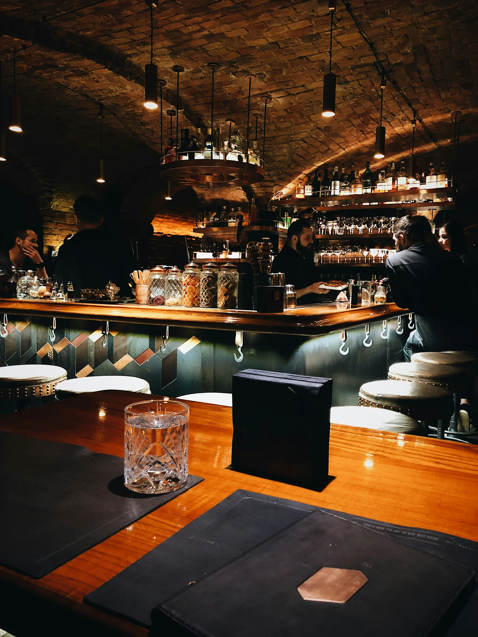 an empty wooden table is in the middle of a bar