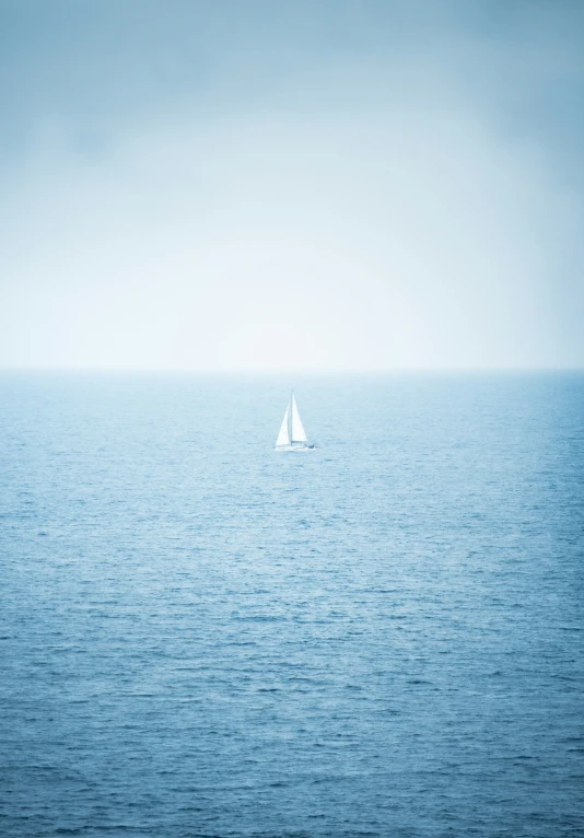 a boat floating on the middle of a large body of water