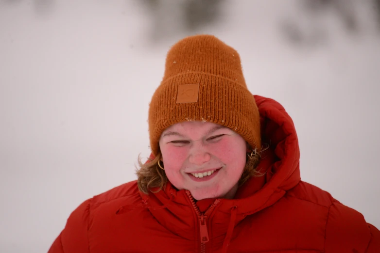 there is a woman wearing a brown hat and smiling