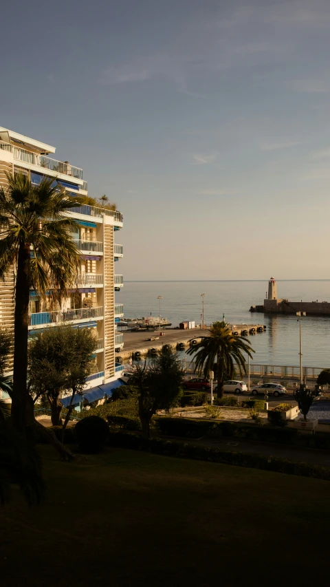 some buildings near the water and palm trees