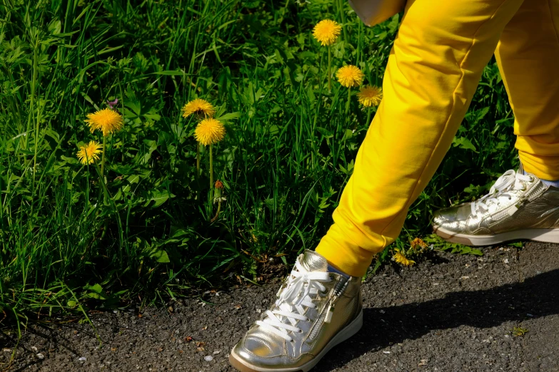 a person standing on their foot with a backpack near some flowers