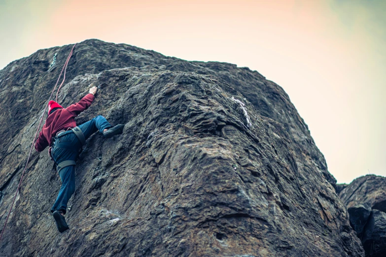 a person is climbing up and down a tall rock